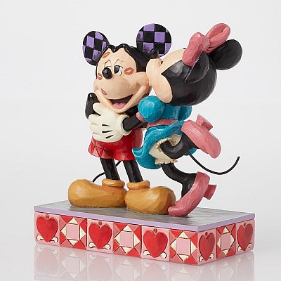 פסלון אמנותי מקסים מתוך סדרת Disney Traditions של Jim Shore — Mickey ו-Minnie מתנשקים על הלחיים (Kisses on Cheeks)